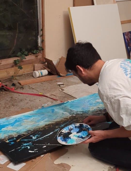 Seb painting in his home studio